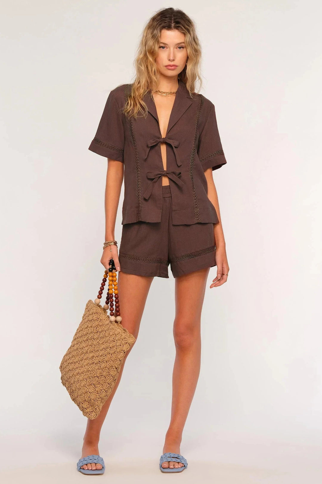 Heartloom Lourdes Set front view- Dear Lucy
Matching linen outfit set featuring a self bow front top and elastic waistband shorts with lace panels throughout in brown.