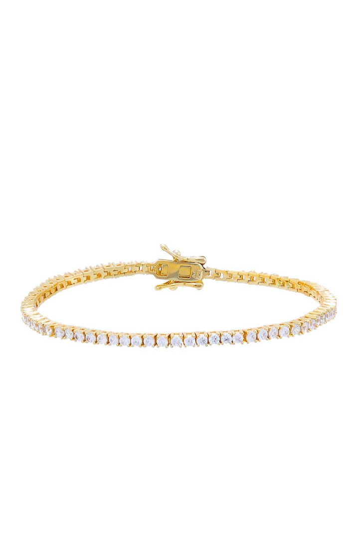 Gold bracelet with diamond-like stones on a white background