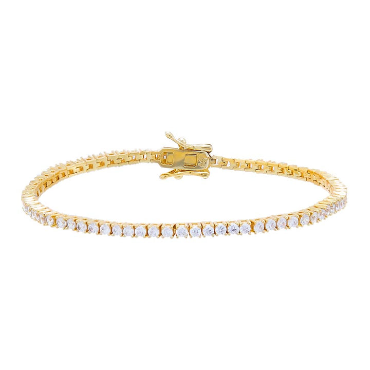 Gold bracelet with clear stones on a white background