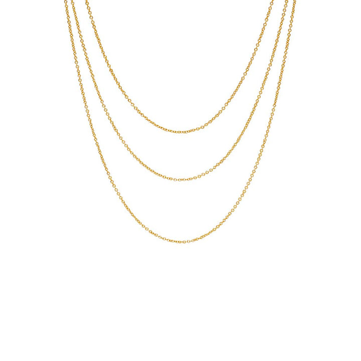 Three gold chains stacked on a white background