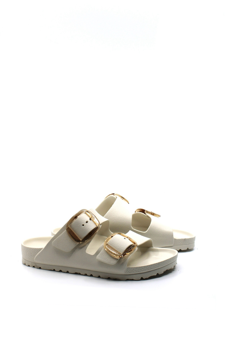 white waterproof sandals with 2 straps and large gold buckle closures.