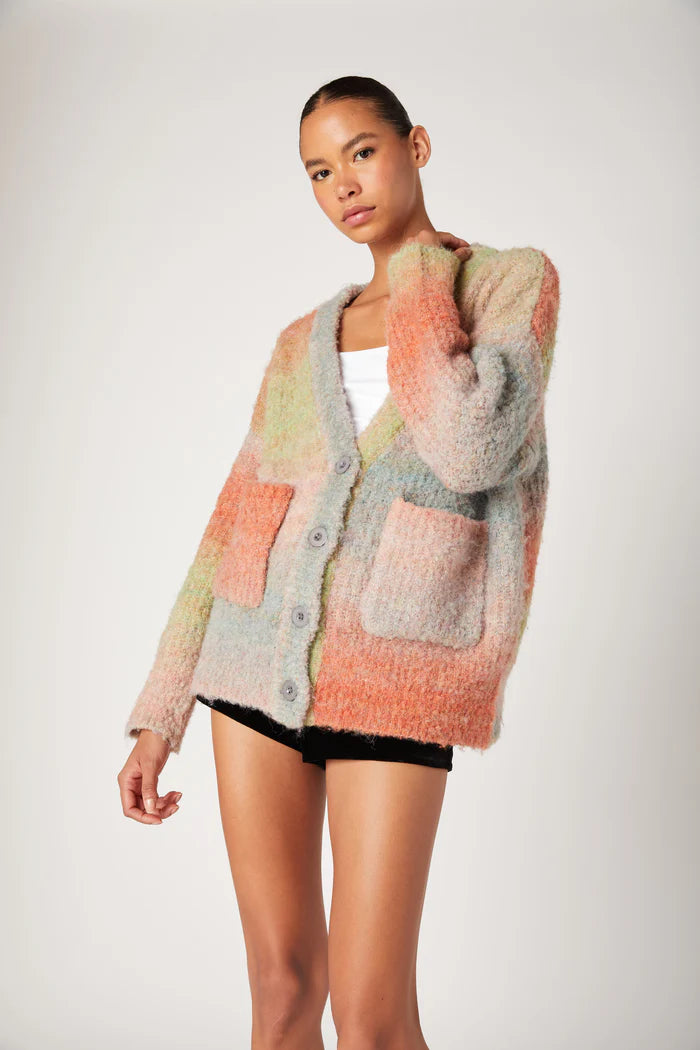 Woman wearing a colorful knitted cardigan on a white background