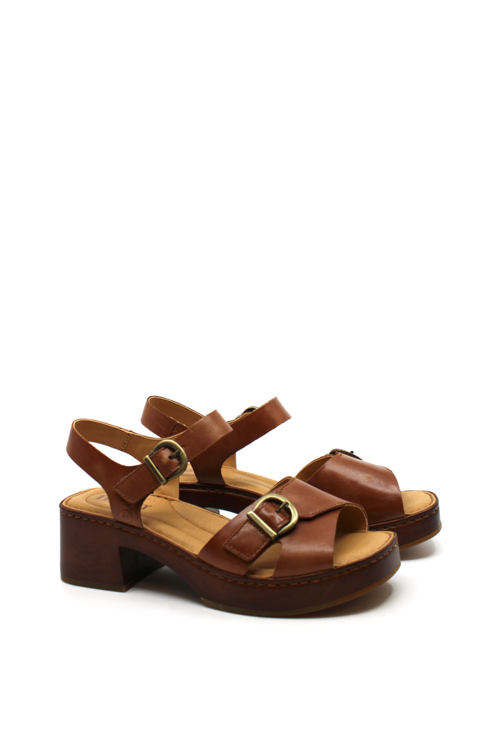 Brown sandals with wooden soles and gold buckle closures 