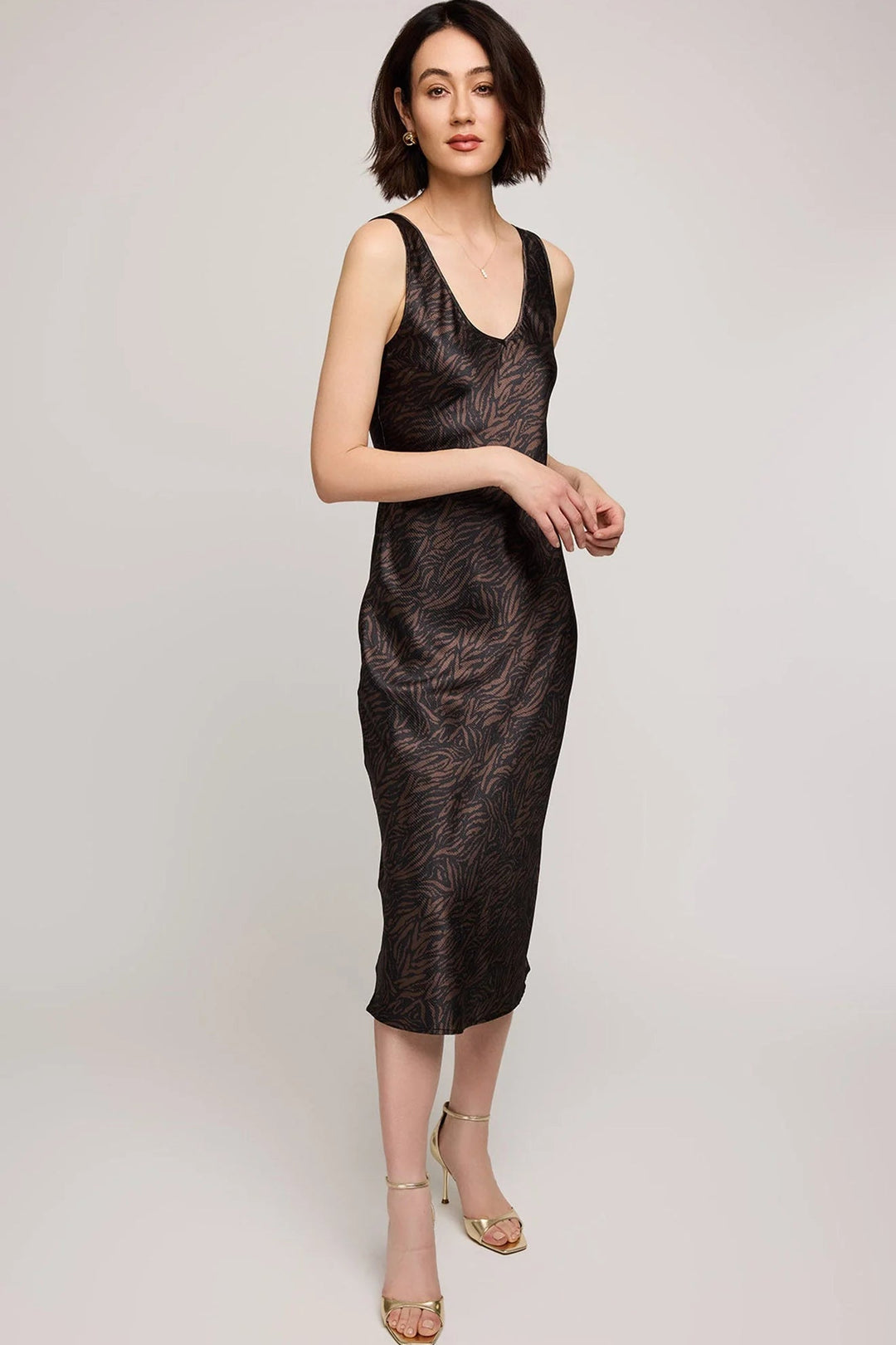 Woman wearing a black textured dress on a light gray background