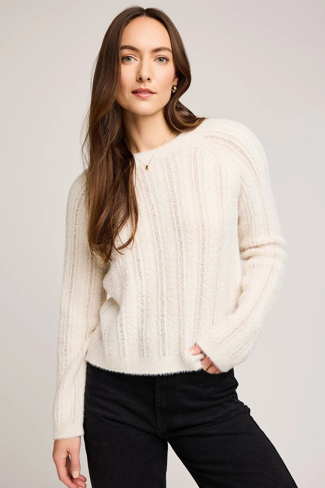 cost knit featuring a raglan sleeve and cable knit stitch pattern