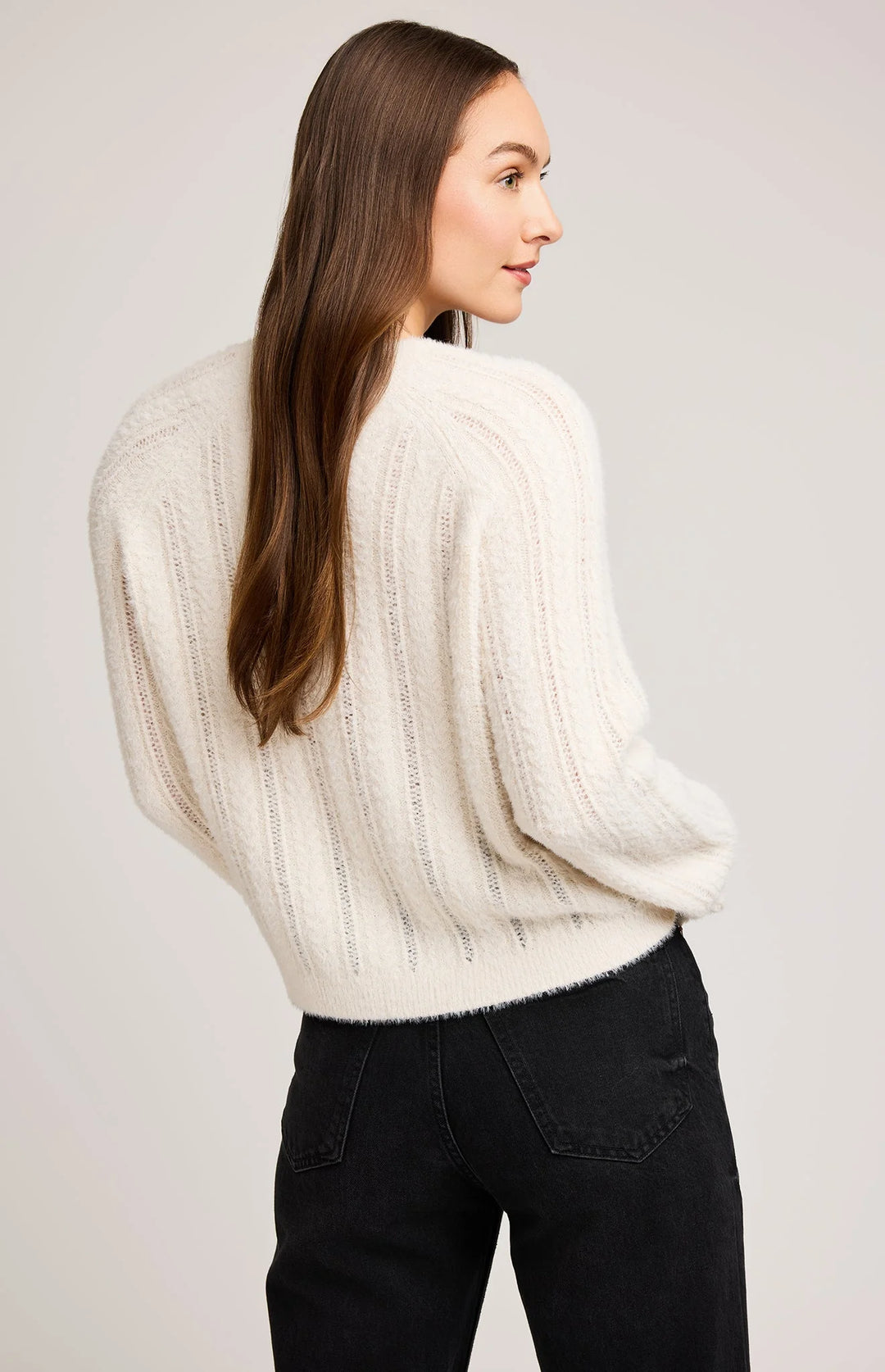 cost knit featuring a raglan sleeve and cable knit stitch pattern