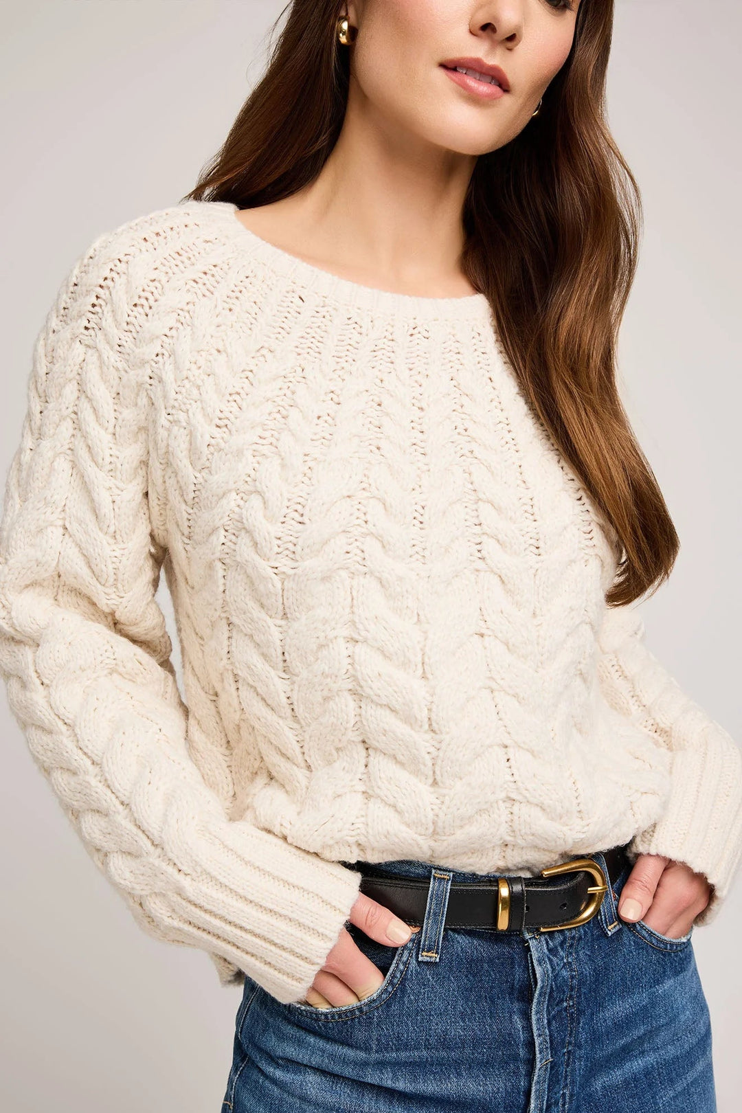 cream cable knit stitch pattern sweater designed with raglan sleeves and wide ribbed cuffs 