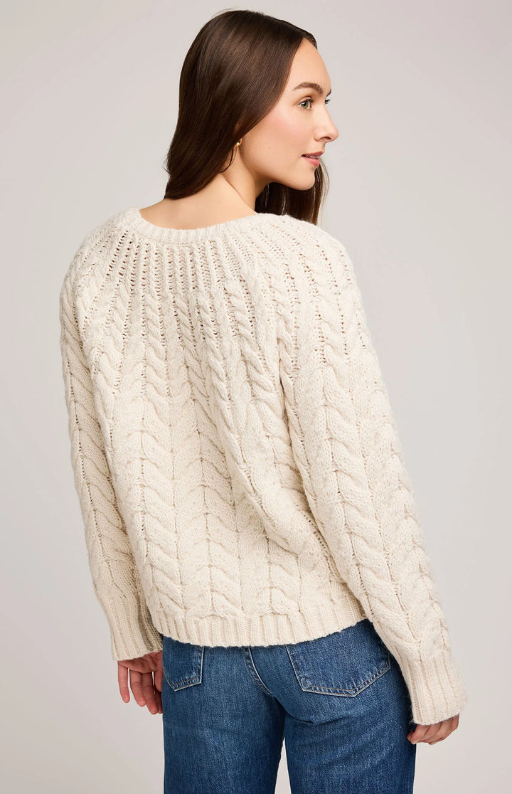 cream cable knit stitch pattern sweater designed with raglan sleeves and wide ribbed cuffs 