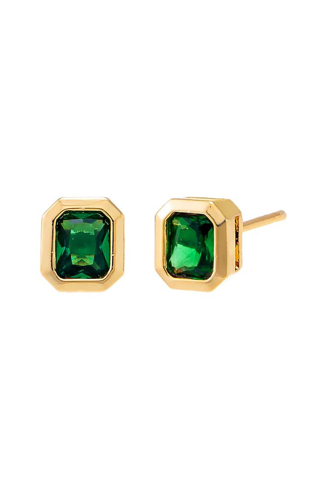 Gold earrings with green gemstones on a white background