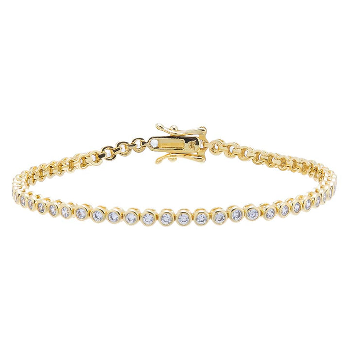 Gold bracelet with clear stones on a white background