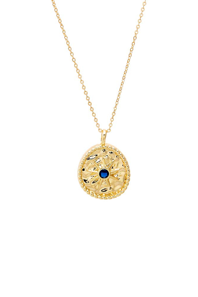 Gold necklace with a blue gemstone pendant on a white background