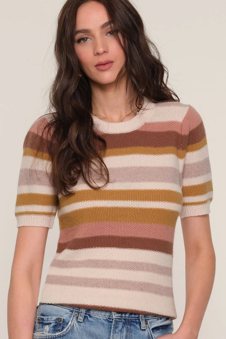 Woman wearing a striped sweater with a plain background