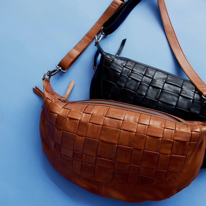 100% Full-grain leather handcrafted by artisans in South America and India. Every hide is unique so you will notice natural variations in the grain texture and shading which are hallmarks of high-quality. Designed for lefties and righties, can be worn as a sling, crossbody, or shoulder bag 1” wide adjustable crossbody strap, 20” max – 10”min drop Top zip entry with leather pull + 2 side zip pockets Interior features organizer with 4 credit card slots, 3 pen holders, zip pocket, and 2 open pockets Cotton Twi
