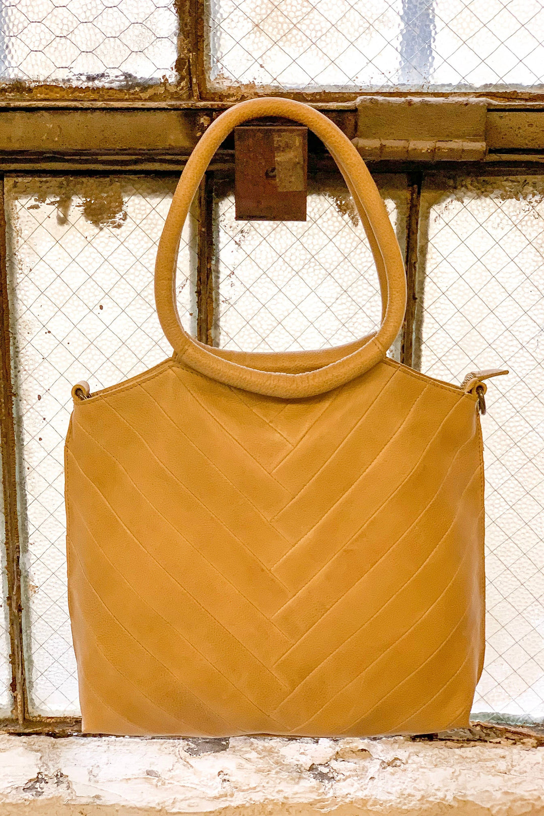Polished, practical, and made to last—the Latico Dalton Tote in Camel is a soft-structured carryall with timeless appeal. Handcrafted from full-grain leather, this roomy tote features clean lines, minimal hardware, and a comfortable shoulder strap. Inside, Latico’s signature organizer helps you keep essentials like your phone, cards, and pens neatly in place. The warm camel hue adds effortless sophistication to your everyday style.
