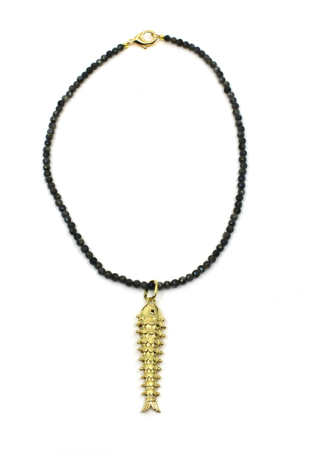 Necklace with black beads and a gold fish pendant on a white background