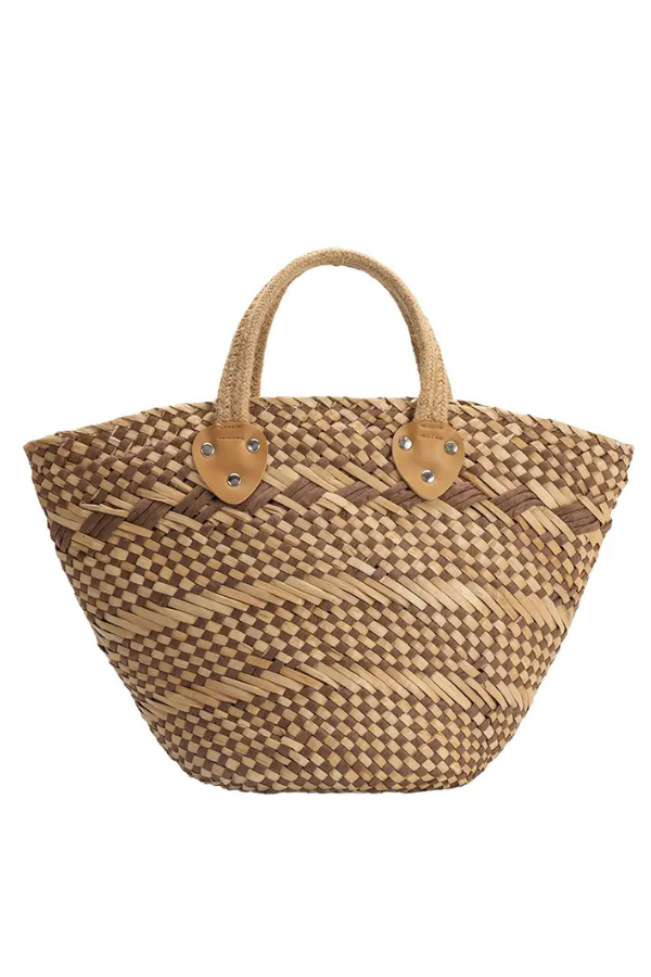 Woven straw bag with brown leather accents on a white background