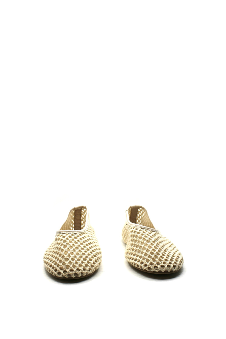Pair of beige woven shoes on a white background