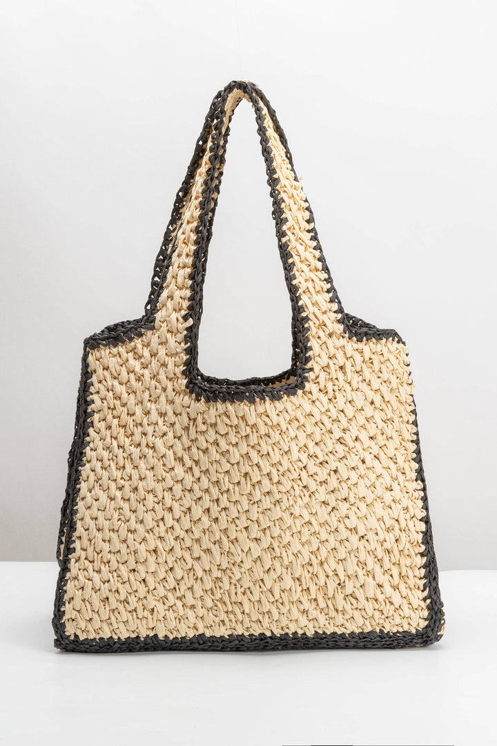 Beige woven handbag with black accents on a white background