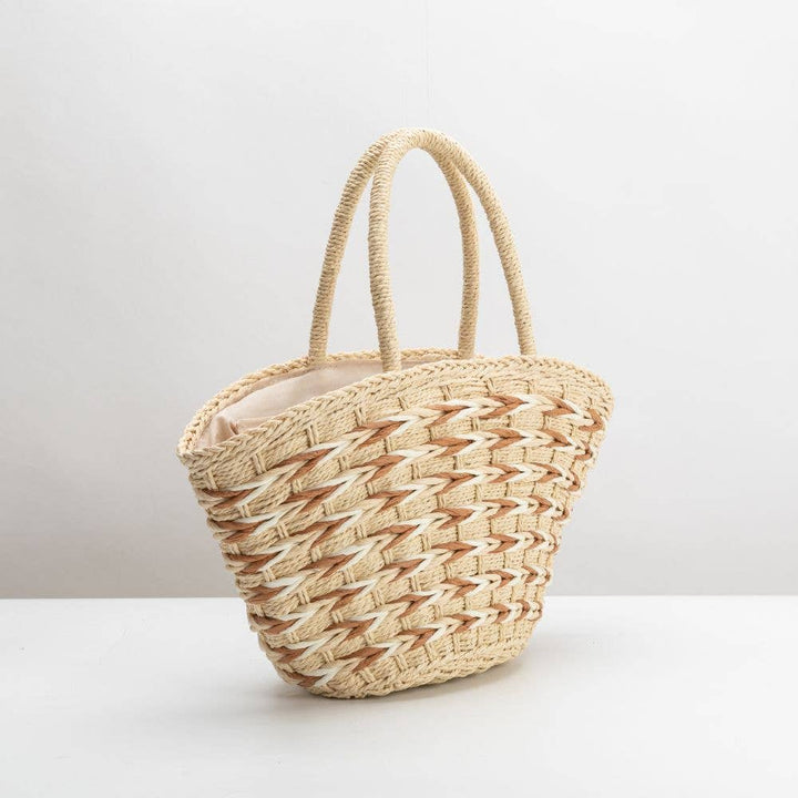 Woven straw bag on a white background
