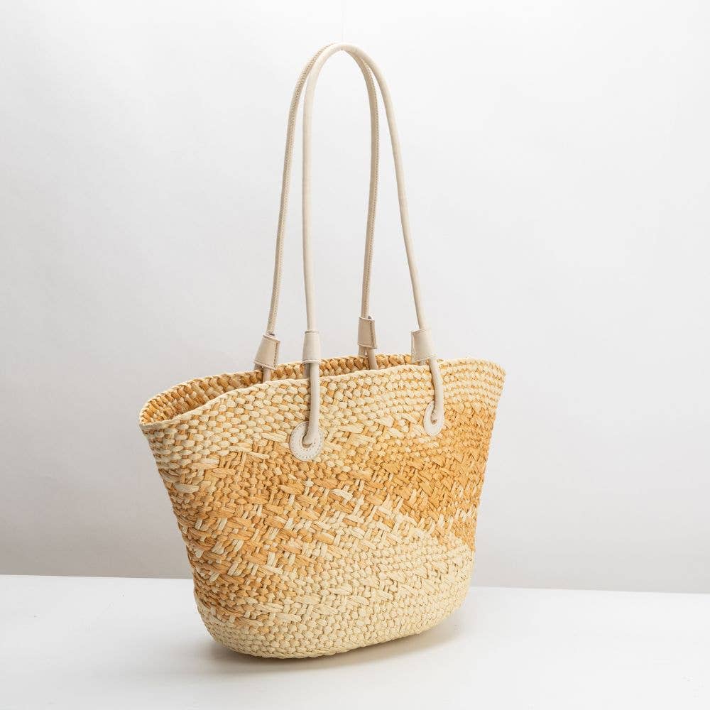 Woven straw bag with beige top and natural bottom on a white background