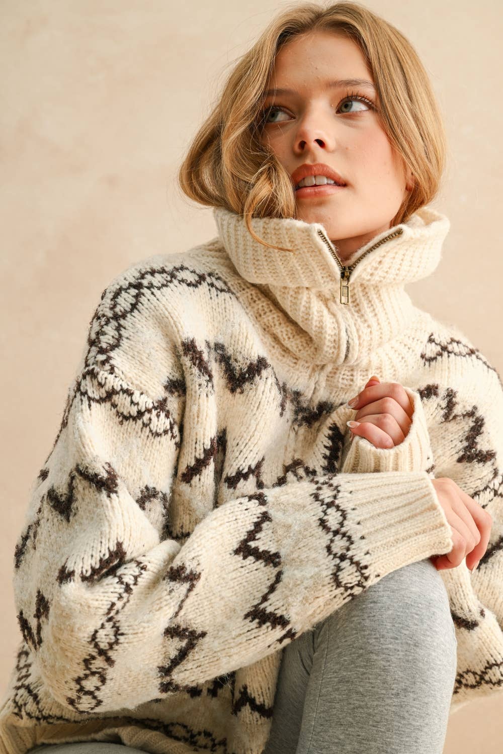 Quarter zip sweater top with black and cream diamond pattern