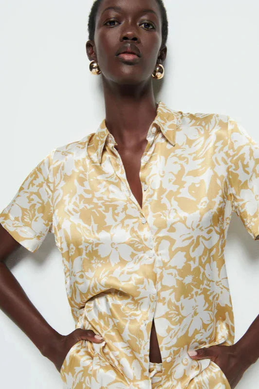 Nation LTD Odin Button Up Shirt in Gold Botanical Floral front view - dear lucy Hammered Satin fabric, button front, collared, blouse with a gold and white botanical flower pattern.