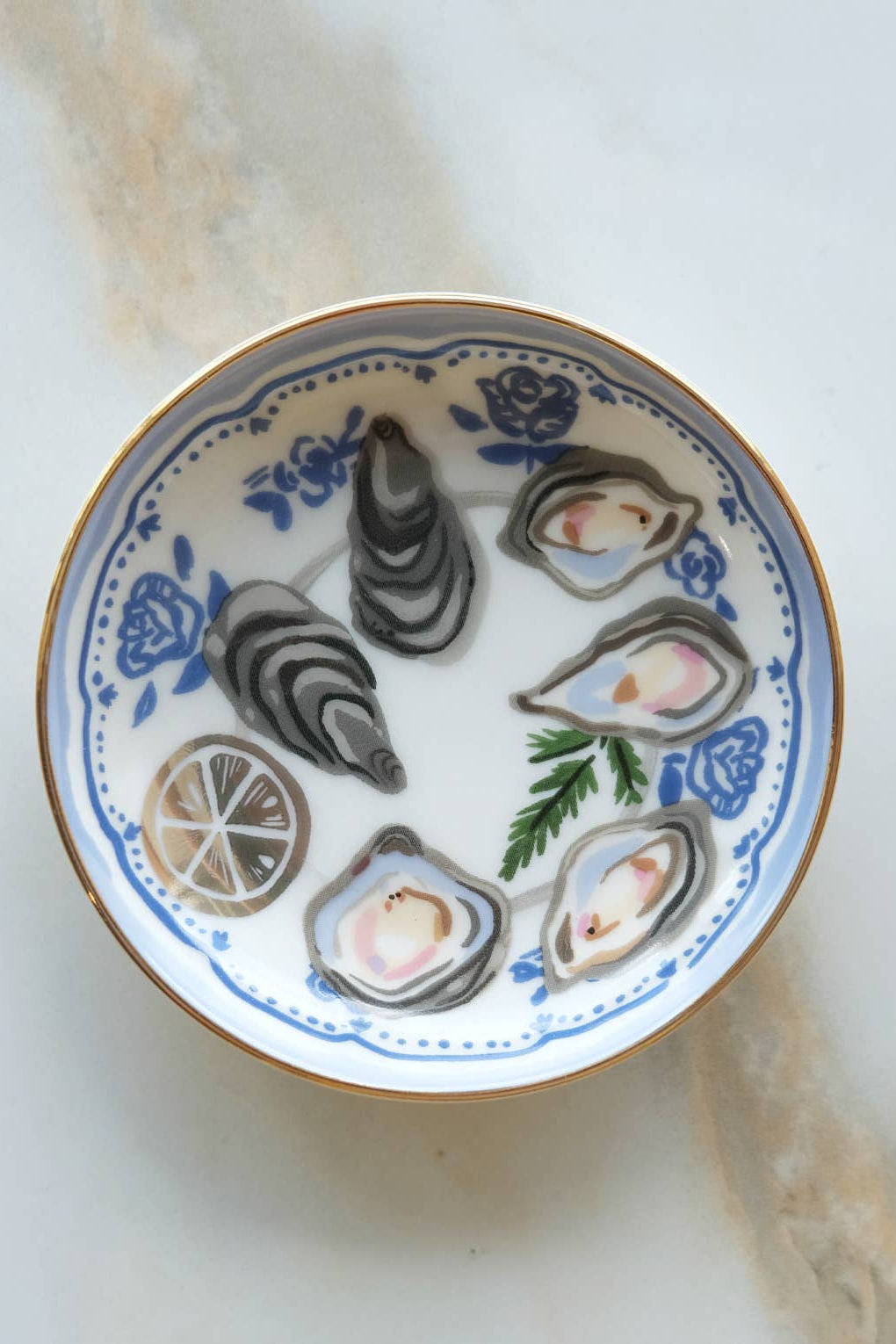 Decorative plate with oyster shells and lemon slices on a white background