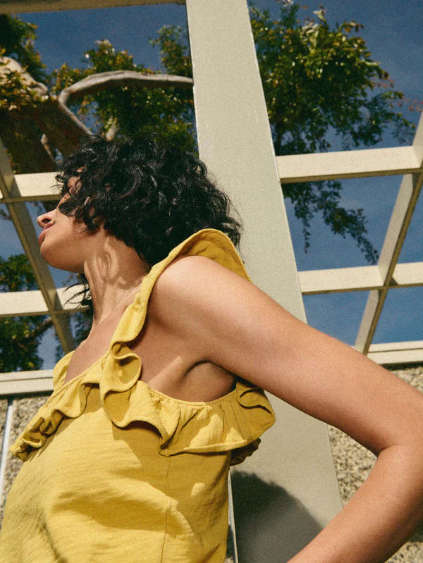 Nation LTD Rosa Solid Ruffle Top in Antique Gold side view- Dear Lucy Gold, slightly cropped, tank top featuring a square neckline and ruffle trim on the straps.