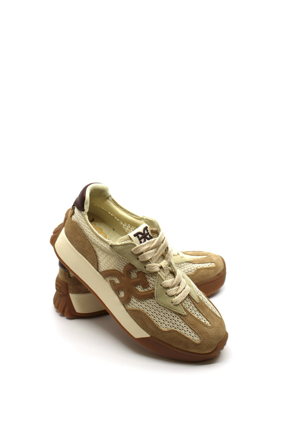 Beige sneaker with brown sole on a white background