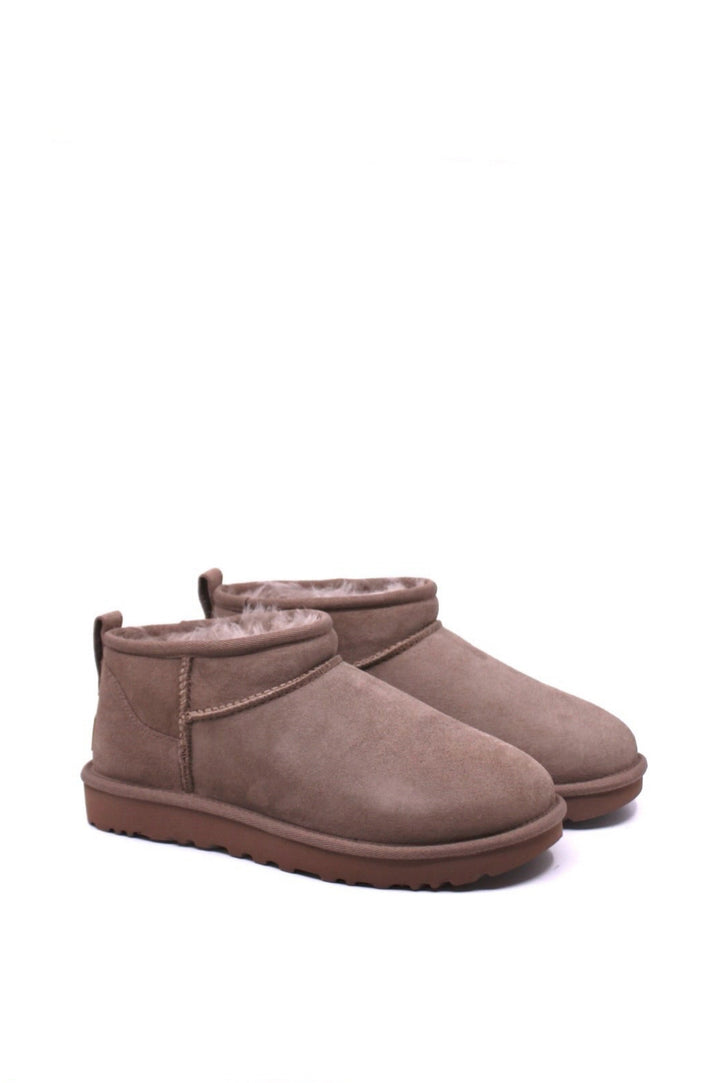 Pair of brown suede boots with fur lining 