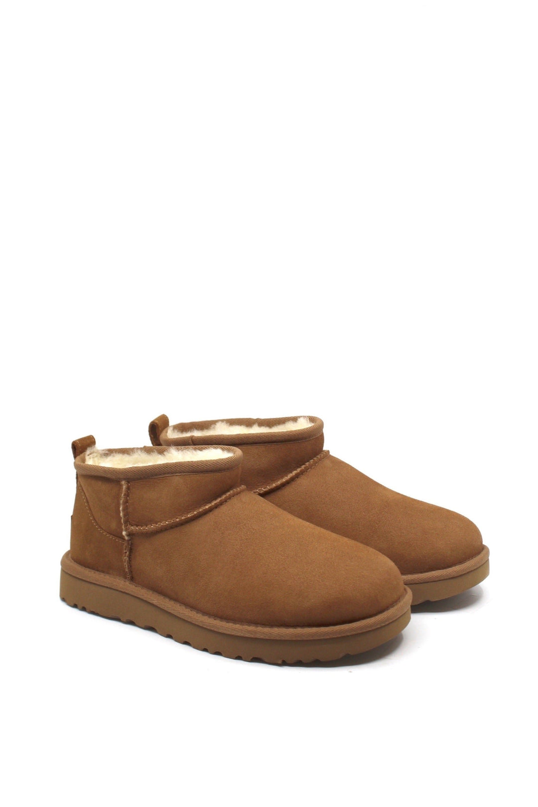 A pair of chestnut colored UGG Classic Ultra Mini boots with a low shaft height, featuring sheepskin lining and a lightweight sole.