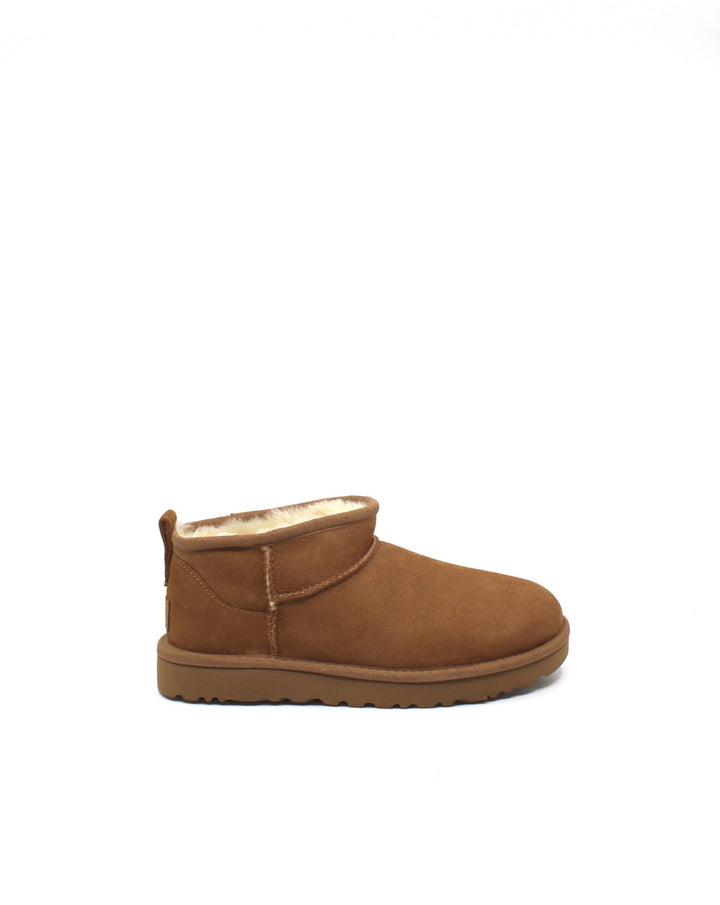 A pair of chestnut colored UGG Classic Ultra Mini boots with a low shaft height, featuring sheepskin lining and a lightweight sole.