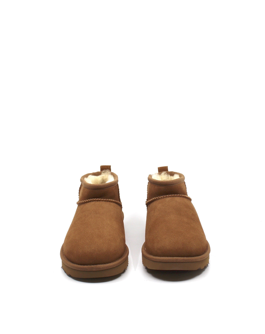 A pair of chestnut colored UGG Classic Ultra Mini boots with a low shaft height, featuring sheepskin lining and a lightweight sole.