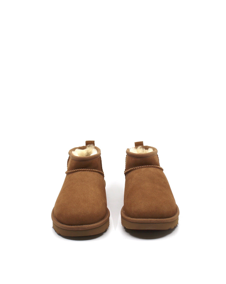 A pair of chestnut colored UGG Classic Ultra Mini boots with a low shaft height, featuring sheepskin lining and a lightweight sole.