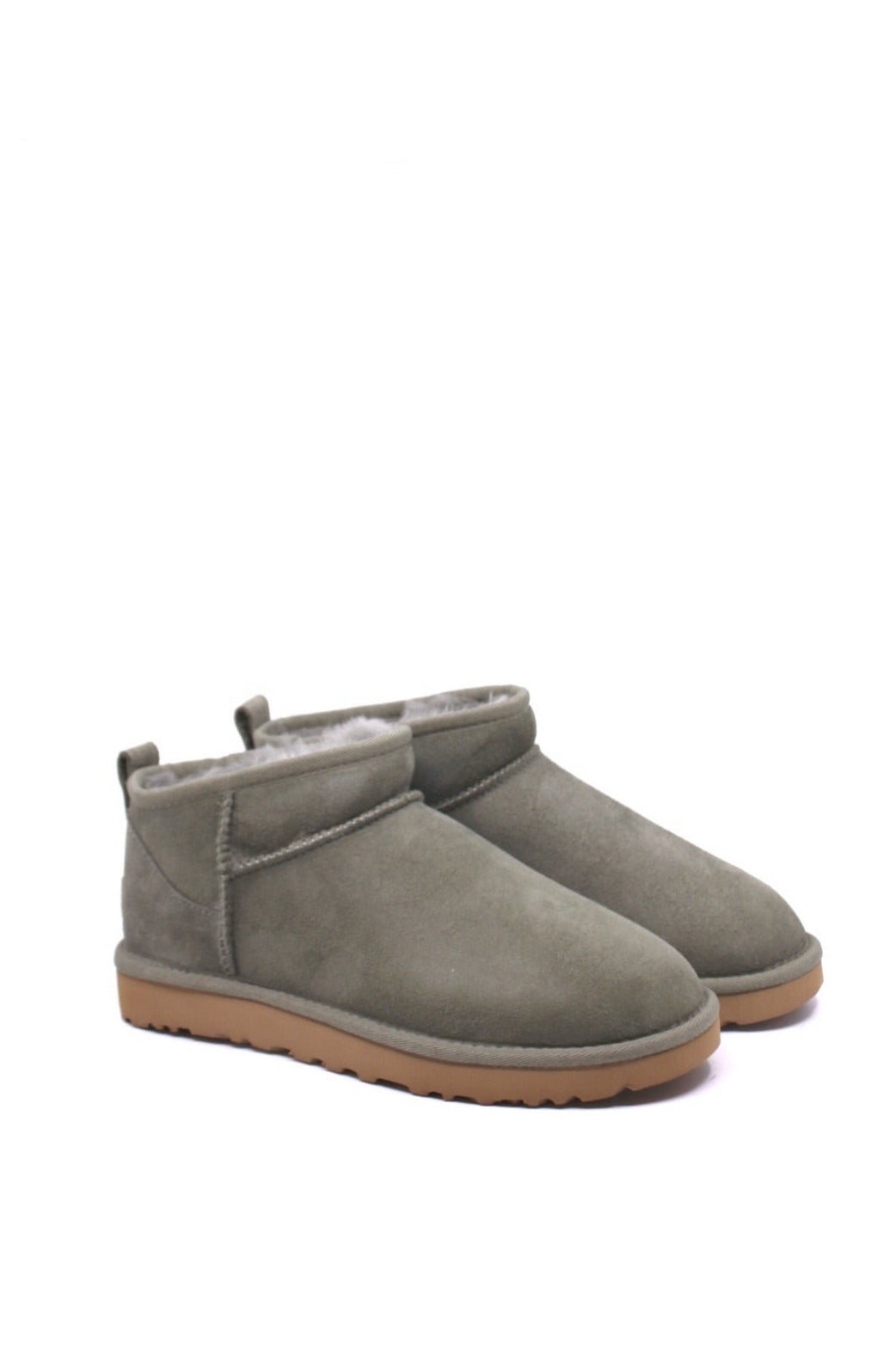 Pair of green suede boots with brown soles and fur lining from UGG