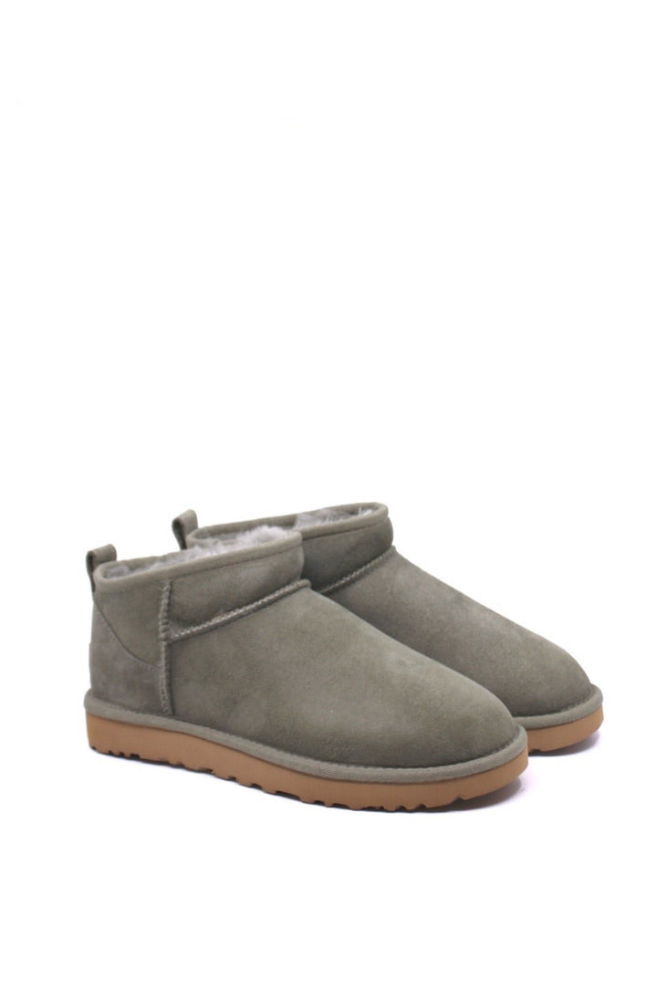 Pair of green suede boots with brown soles and fur lining from UGG