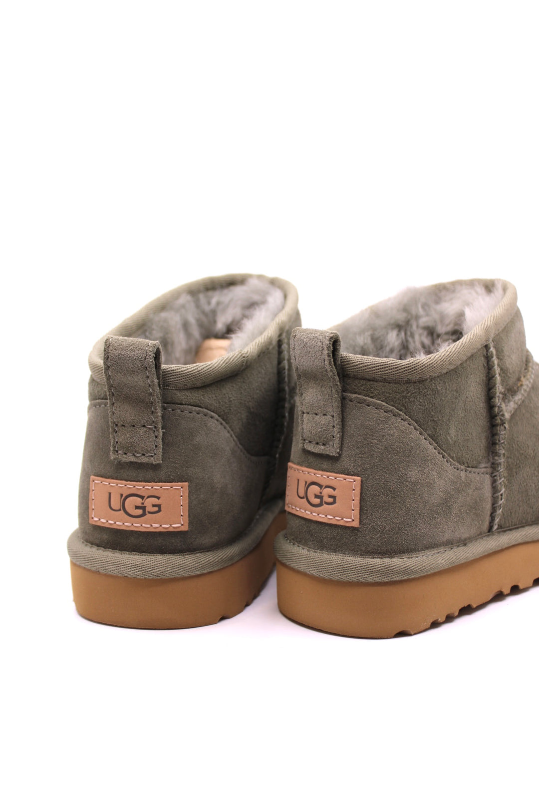 Pair of green suede boots with brown soles and fur lining from UGG