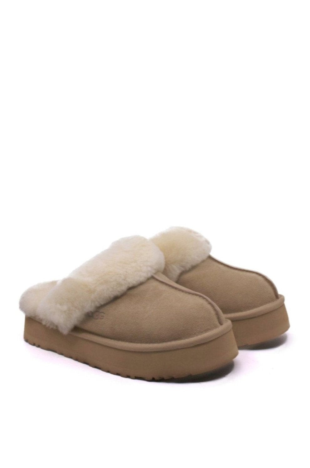 A pair of UGG Disquette Sand slippers with a beige suede upper and sheepskin lining.