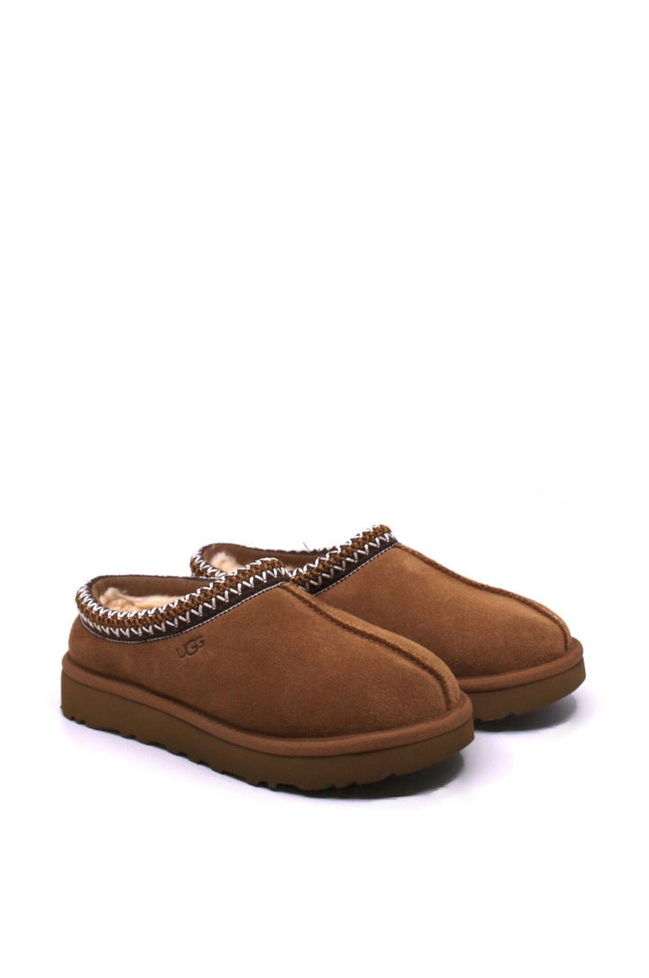 Pair of brown slippers with brown trim and fur lining from UGG