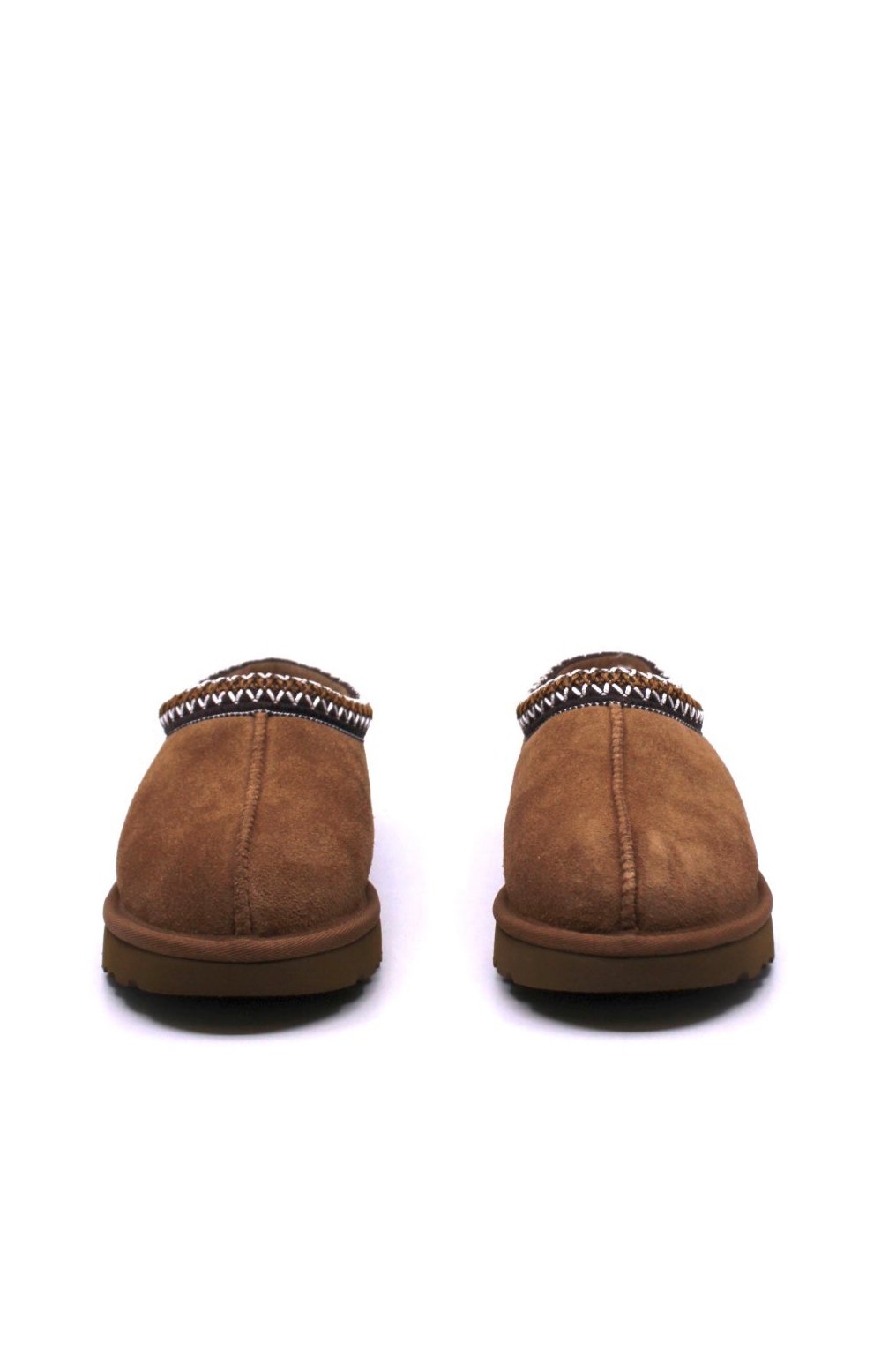 Pair of brown slippers with brown trim and fur lining from UGG