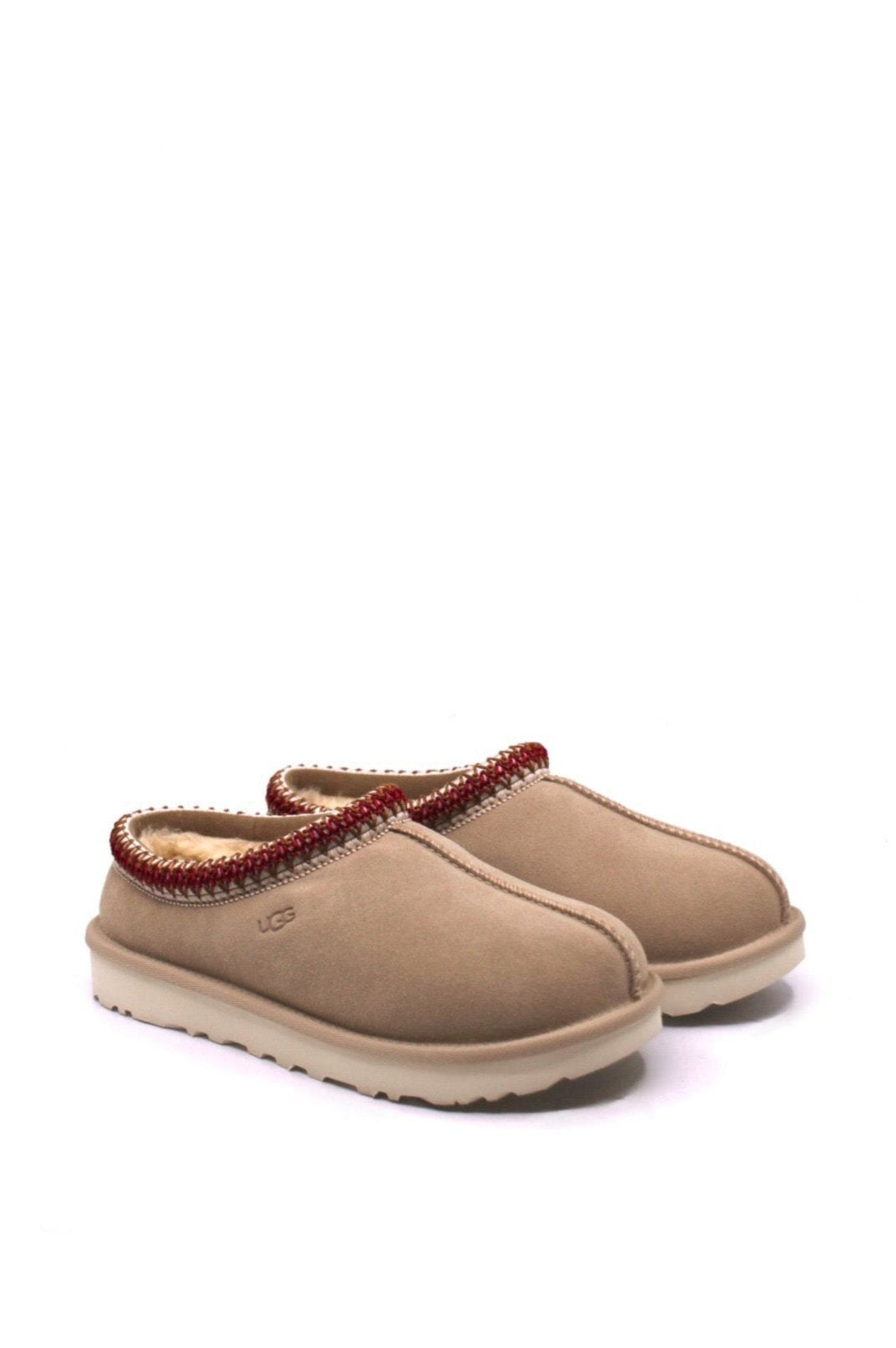 Pair of tan slippers with red trim and fur lining from UGG