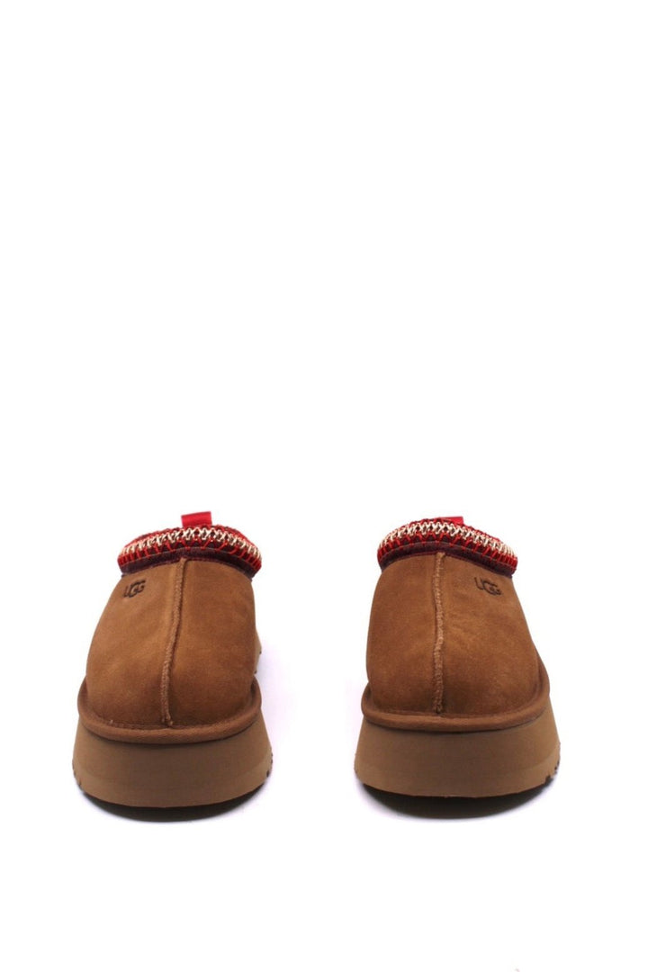 Brown slippers with red trim and platform sole from UGG  