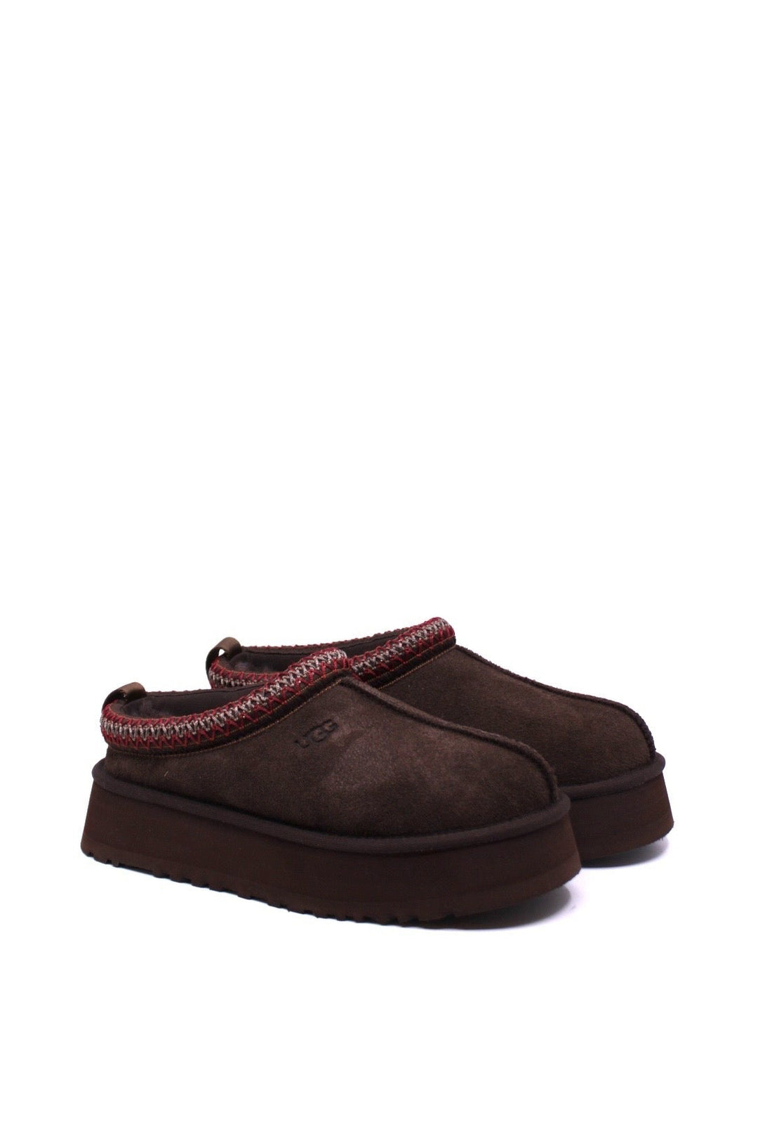 Pair of brown UGG slippers with red trim on a white background