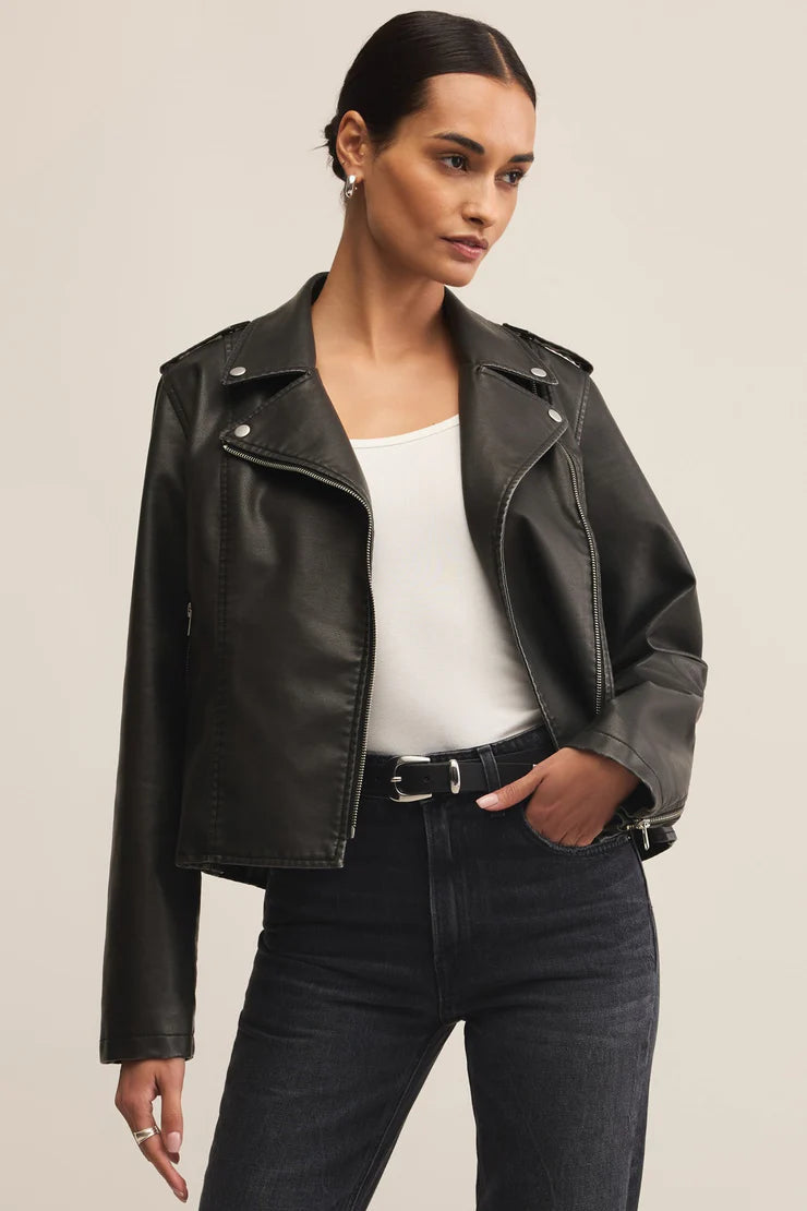 Woman wearing black zip up leather jacket 