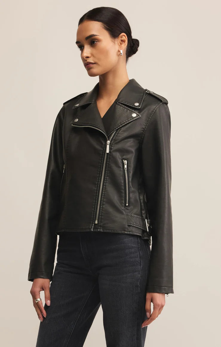 Woman wearing black zip up faux leather jacket 