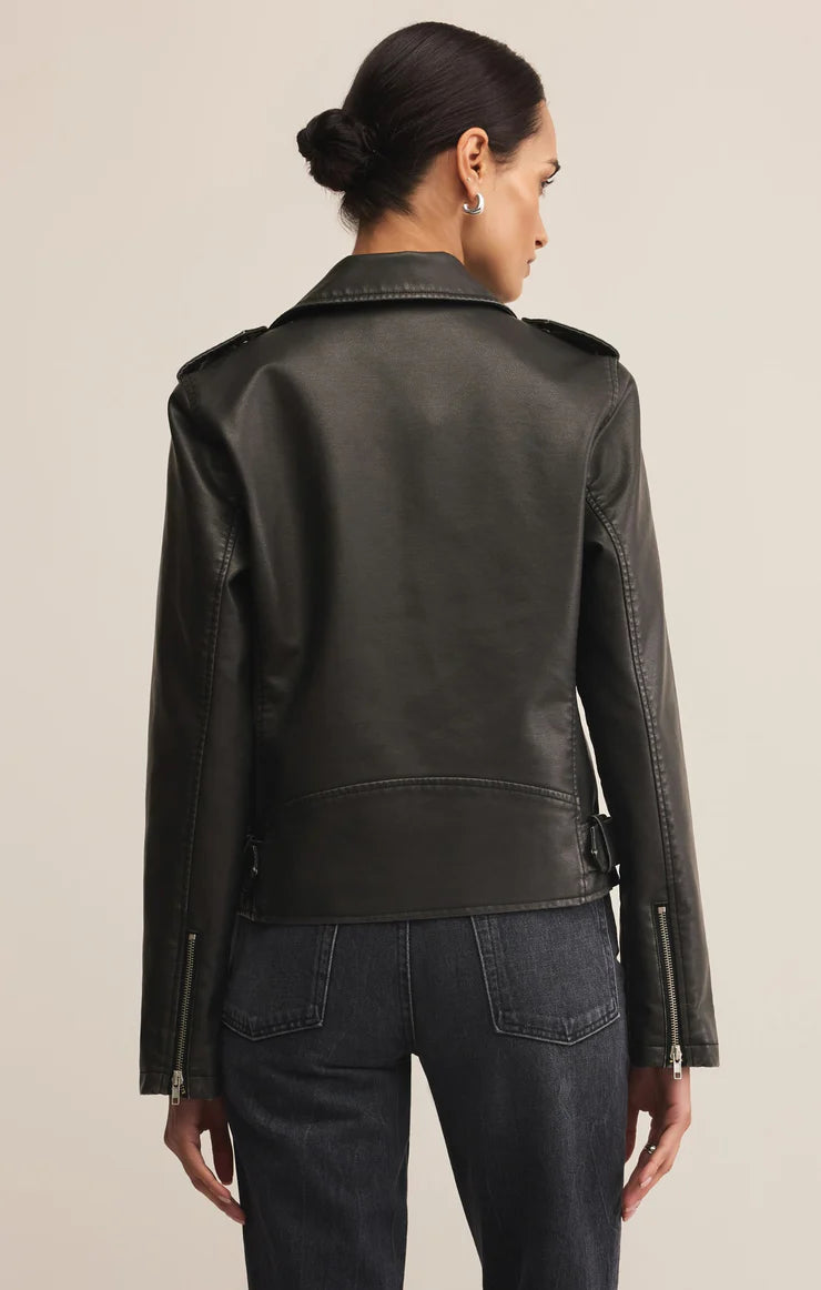 Woman wearing black zip up faux leather jacket 