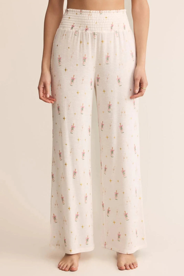 White pants with a subtle pattern worn by a person on a beige background