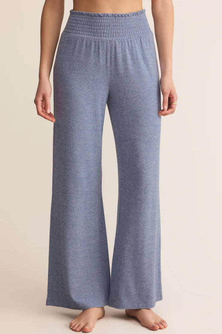  Smocked Pant in Blue Velvet worn by a person on a beige background