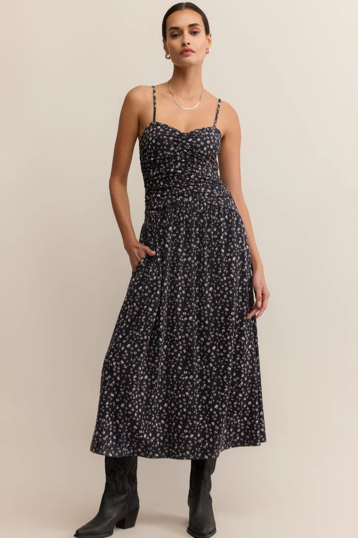  A maxi dress featuring a feminine ditsy floral print, with a  fitted silhouette, a sweetheart neckline, adjustable spaghetti straps, and smocking for a perfectly contoured fit