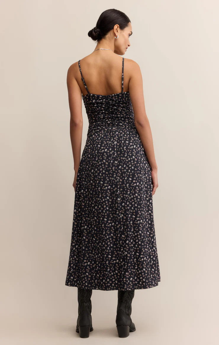  A maxi dress featuring a feminine ditsy floral print, with a  fitted silhouette, a sweetheart neckline, adjustable spaghetti straps, and smocking for a perfectly contoured fit